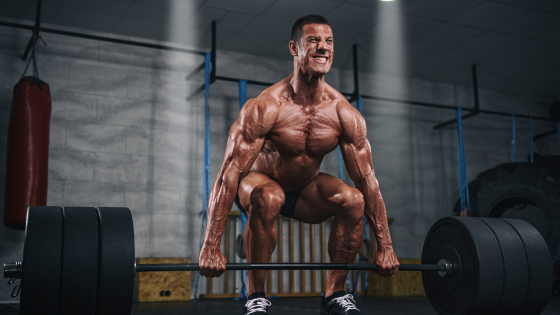 A man lifting weights after taking muscle building supplements